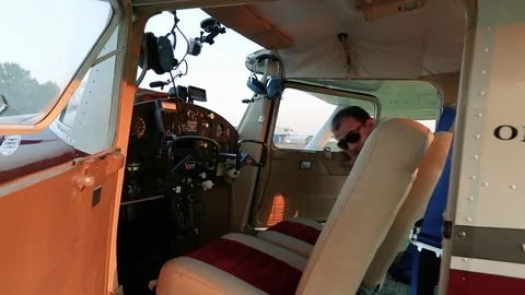 The pilot sits down in the cockpit. Stock Footage 80318362