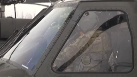 Pilot sitting in cockpit of UH-60 Blackhawk helicopter Stock Footage 87017913