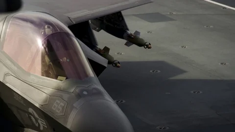 Pilot sitting inside cockpit of F-35B aboard HMS Queen Elizabeth Stock Footage 98927657