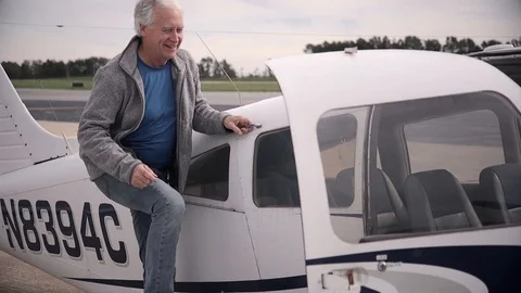 Pilot Smiling and Climbing into Small Piper Archer Airplane Stock Footage 99267724