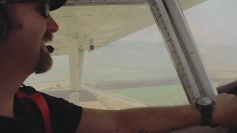 Pilot smiling while flying airplane Stock Footage 275381041