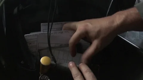 Pilot sorting paperwork in cockpit of C-130H Hercules 스톡 동영상 81477905
