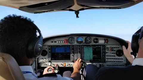 Pilot student selecting autopilot mode in DA42 twin engine aircraft Stock Photos