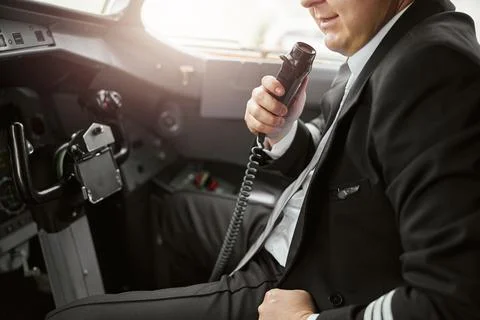 Pilot talk information on microphone to passengers Stock Photos