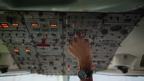 Pilot touching controls in airplane cockpit, control center 库存影片 220301962