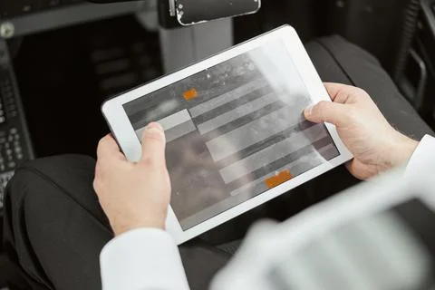 Pilot use digital tablet in passenger airplane jet Stock Photos