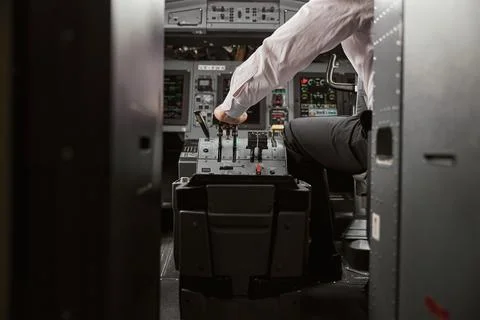 Pilot use steering to fly on passenger airplane Stock Photos