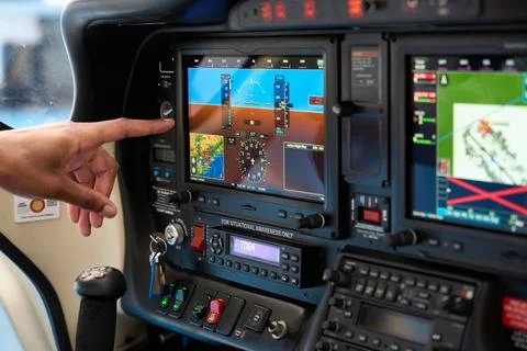 Pilot using touch screen in airplane cockpit during flight training Stock Photos