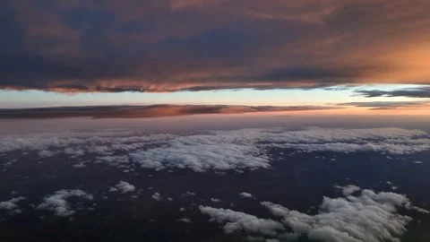 Pilot View Flying Between Layers of Darkening Ethereal Stratus Clouds Bathed in Stock Footage 333387615