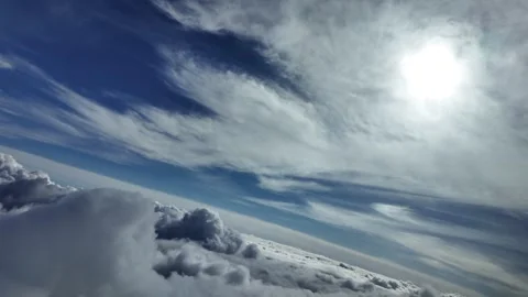 A Pilot View Flying over a Heavenly Sky with a Shining Sun Veiled by Ethereal Vídeos de archivo 308900631