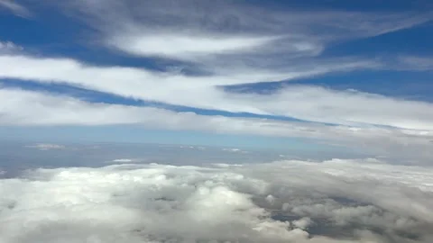 Pilot View Flying Pecefully in Blue Sky Between Layers of Clouds in a Deep Blue Stock Footage 345734962