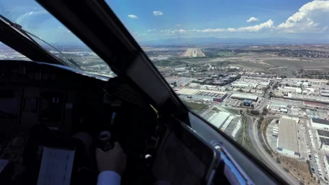 Pilot View Though the Cockpit Window of a Jet Airplane in the Final Approach to Stock Footage 334443945