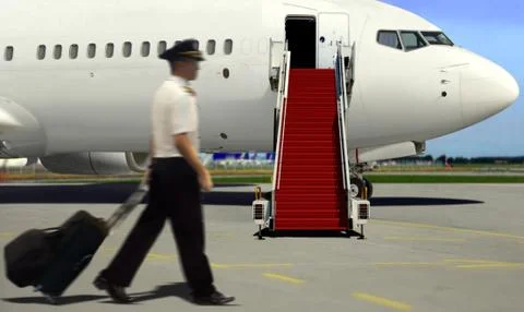 Pilot walking to airplane for take off Stock Photos