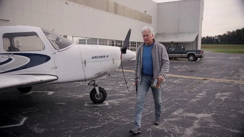 Pilot Walking Around Piper Archer Airplane on Runway Stock-Footage 99268321