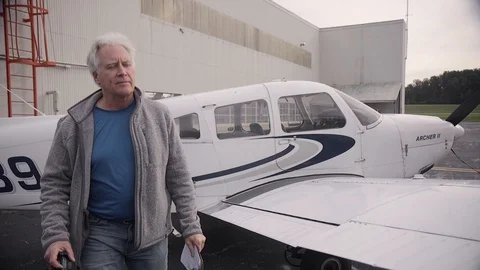 Pilot Walking Around Piper Archer Airplane on Runway Stock Footage 99268389