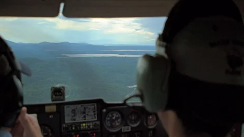 Piloting a small plane over beautiful scenery aerial shot Video stock 129399335