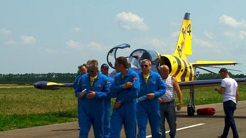 Pilots from Baltic Bees aerobatic team leave parking place of L-39 aircraft. Stock Footage 106553576
