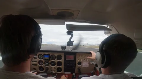Pilots In Cockpit Taking Control Of Small Aircraft Taxiing In Runway In Video stock 202021918