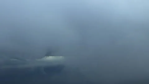 Pilot’s Eye View Ascending Through a Thin Cloud Layer While Turning Right Stock Footage 325018814