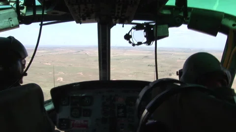 Pilots flying a Huey helicopter from inside Stock Footage 45532991
