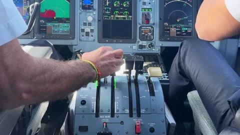 Pilots hands touching the controls in the flight deck of a commercial airliner Video stock 179214682