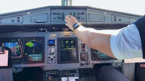 Pilots hands touching the controls in the flight deck of a commercial airliner Video stock 179215468