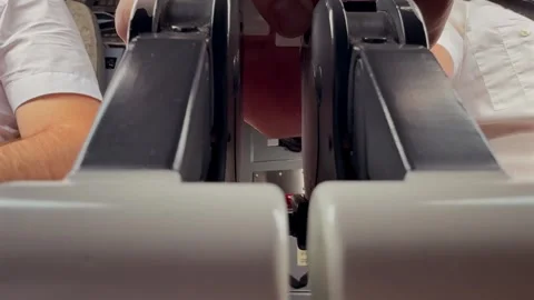 Pilots Inside a Jet Airplane Cabin During the Taxi Adjusting the Thrust Levers Stock Footage 336737696