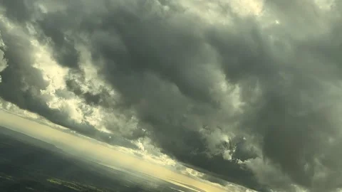 A Pilot’s Perspective From Cockpit: Flying Under a Threatening Stormy Sky in a Stock Footage 304872357
