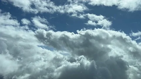 A pilot’s perspective: flying through a blue sky with some tiny cumulus. Stock Footage 235712534