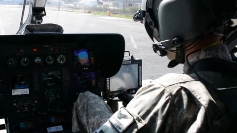 Pilots set controls in the cockpit of a UH-72 Lakota helicopter Stock Footage 112127264