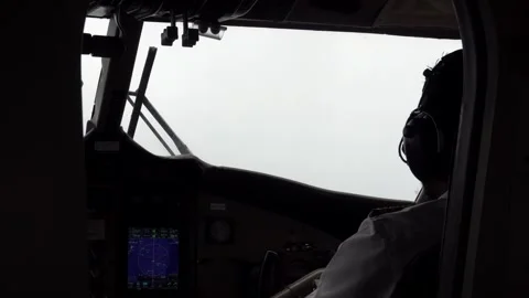 The pilots sit at the controls of the seaplane Stock Footage 295788855