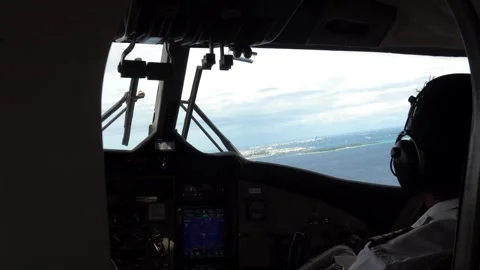 The pilots sit at the controls of the seaplane Stock Footage 297746550