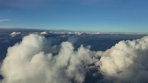 A PIlot’s View From a Jet Cockpit: Flying Over Cottony Clouds Over the Sea with Stock Footage 305015361