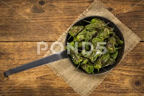 Pimientos de Padron on wooden background; selective focus Stock Photos