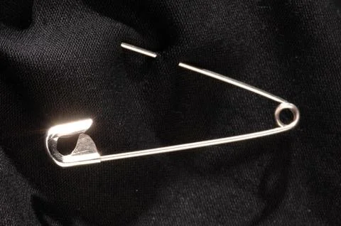 Pin on a black material 스톡 사진