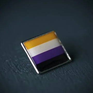 Pin button patterned with a non-binary pride flag Stock Photos