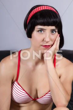 Pin-up girl with bikini on the sofa Stock Photos
