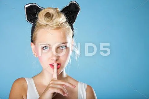 Pin up girl finger near mouth silence gesture Stock Photos