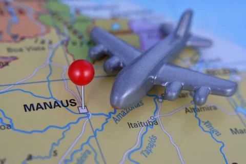 Pin marked city of Manaus on map in Brazil with plane Stock Photos