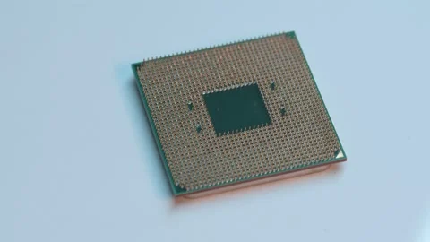 Pin side of a AMD Ryzen 5 1600 AM4 computer processor on a table Stock Footage 236472168