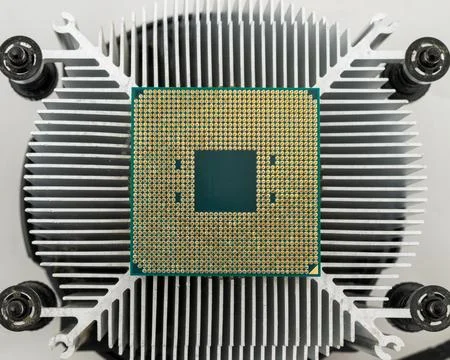 Pin side of a CPU processor mounted on a cooler. 스톡 사진