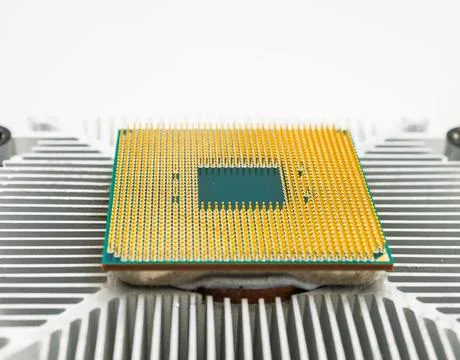Pin side of a CPU processor mounted on a cooler. 스톡 사진