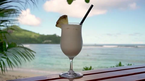 Pina colada cocktail close-up on the background of the ocean Stock Footage 154807516