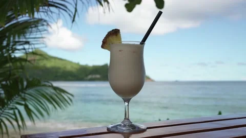 Pina colada cocktail close-up on the background of the ocean Stock Footage 154807567