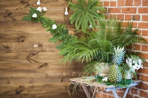 Pinapple on the table decorated with flowers 库存照片