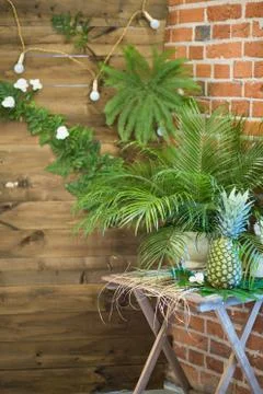 Pinapple on the table decorated with flowers 写真素材