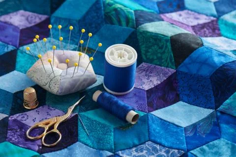 Pincushion, spools of thread, scissors and thimble on the tumbling blocks qui Stock-Fotos