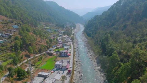 Pindar river flowing between the mountains in Uttarakhand and a small town .. Stock Footage 304421892