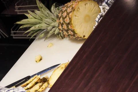 Pine apple with knife on table Stock Photos