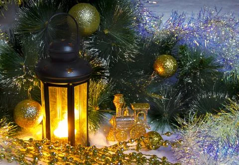 Pine branches and burning wax candles on the snow Stock Photos